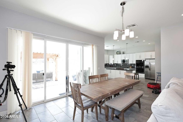 tiled dining area with a notable chandelier