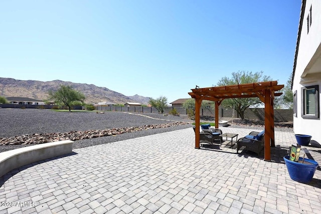 view of patio with a mountain view, outdoor lounge area, and a pergola