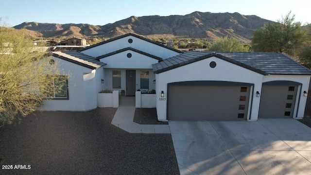 view of front of house with a mountain view and a garage