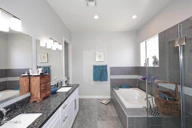 bathroom featuring shower with separate bathtub and vanity