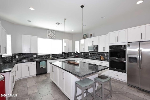 kitchen featuring white cabinetry, a kitchen island, and stainless steel appliances