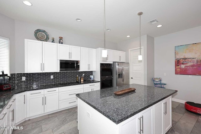 kitchen with decorative backsplash, appliances with stainless steel finishes, decorative light fixtures, a kitchen island, and white cabinetry