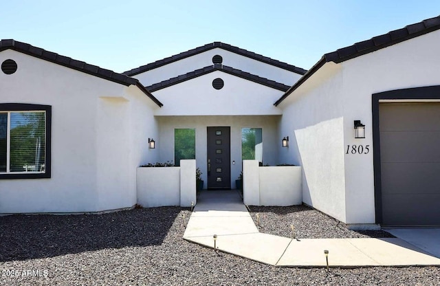 doorway to property with a garage