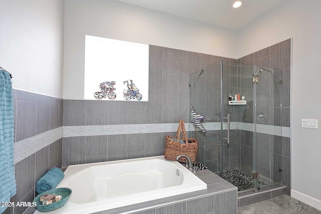 bathroom with separate shower and tub