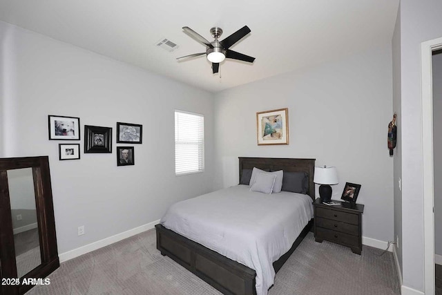 bedroom with ceiling fan and light carpet