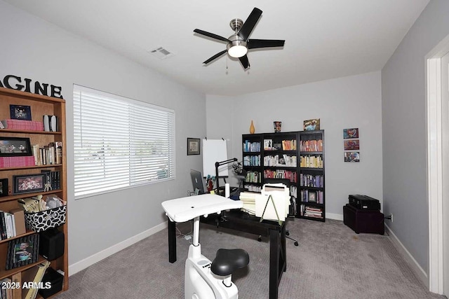 home office with ceiling fan and light colored carpet