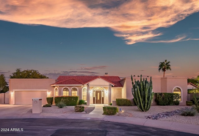 mediterranean / spanish-style house featuring a garage