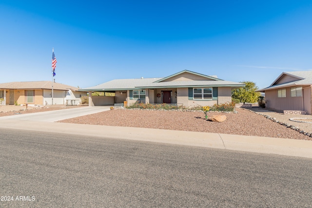 ranch-style house featuring a carport