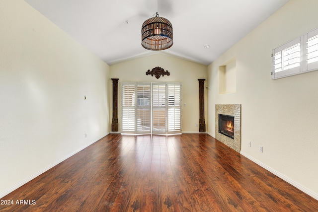 unfurnished living room featuring dark wood-type flooring and lofted ceiling