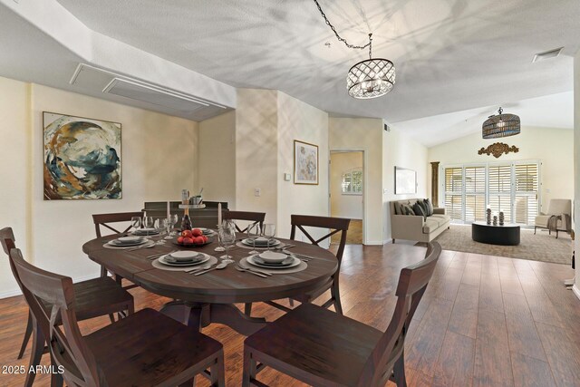 8653 E Royal Palm Rd Unit 2005, Scottsdale, AZ 85258 - unfurnished living room with plenty of natural light, wood finished floors, vaulted ceiling, a glass covered fireplace, and a chandelier