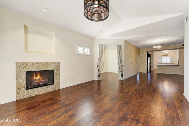 unfurnished living room featuring dark hardwood / wood-style floors, ceiling fan, and lofted ceiling