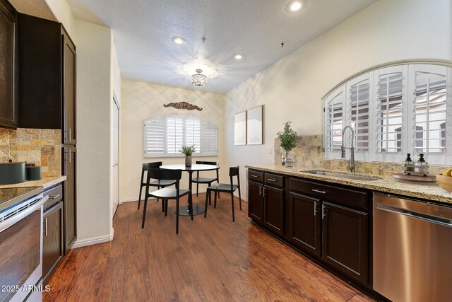 8653 E Royal Palm Rd Unit 2005, Scottsdale, AZ 85258 - unfurnished living room featuring a high end fireplace, hardwood / wood-style flooring, a chandelier, and vaulted ceiling