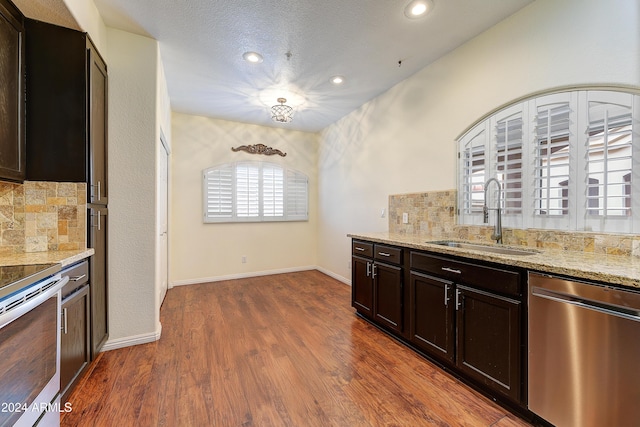 kitchen with decorative backsplash, sink, dark wood-type flooring, and appliances with stainless steel finishes