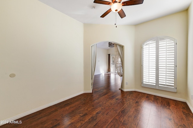 spare room featuring dark hardwood / wood-style floors and ceiling fan