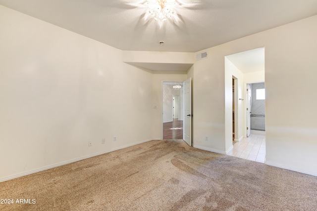 spare room featuring light colored carpet