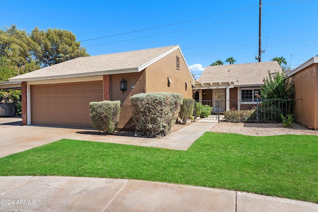 view of front of property with a front yard and a garage