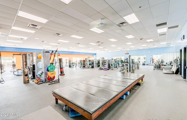 workout area with a paneled ceiling