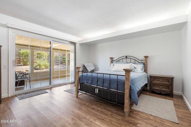 bedroom featuring access to outside and hardwood / wood-style flooring