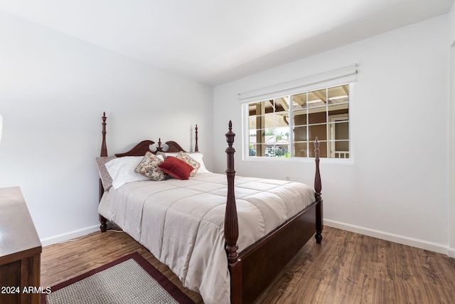 bedroom with dark wood-type flooring