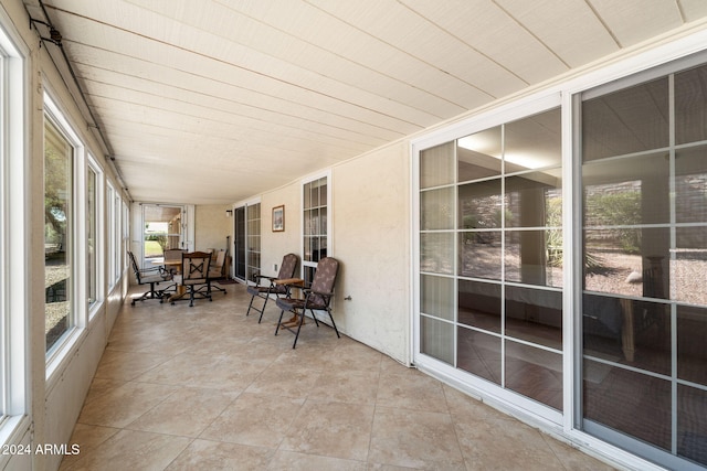 sunroom / solarium featuring wood ceiling