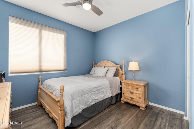 bedroom with dark wood-type flooring, multiple windows, and baseboards