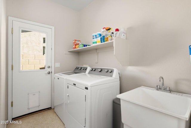 clothes washing area with laundry area, a sink, and separate washer and dryer