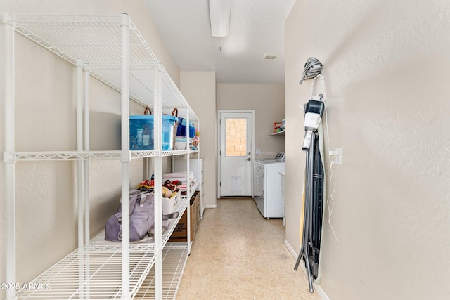 laundry area with laundry area, separate washer and dryer, light floors, and visible vents