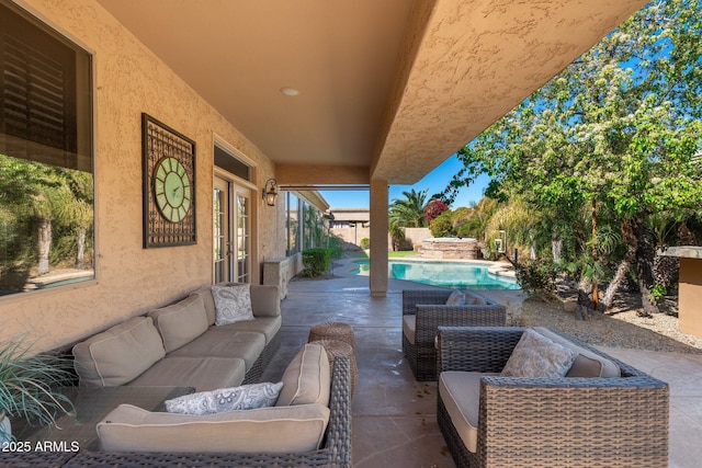 view of patio featuring a fenced in pool, french doors, and an outdoor living space