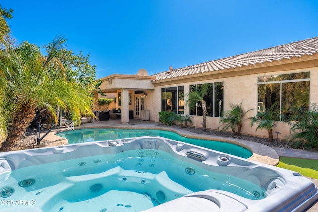 view of swimming pool with an outdoor hangout area, a patio area, and an outdoor hot tub