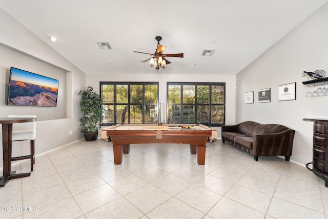 game room with lofted ceiling, visible vents, baseboards, and light tile patterned floors