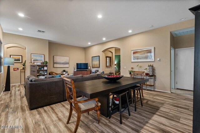 living room featuring light hardwood / wood-style flooring and a chandelier