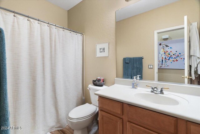 bedroom with ceiling fan, light wood-type flooring, connected bathroom, and multiple windows