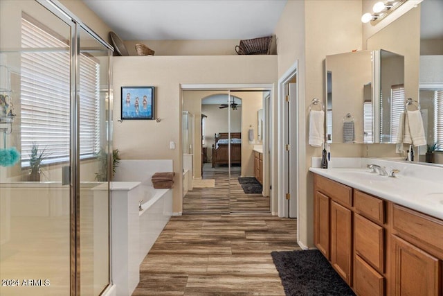 bathroom featuring shower with separate bathtub, vanity, and hardwood / wood-style flooring