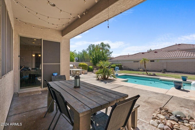 view of patio / terrace with a fenced in pool