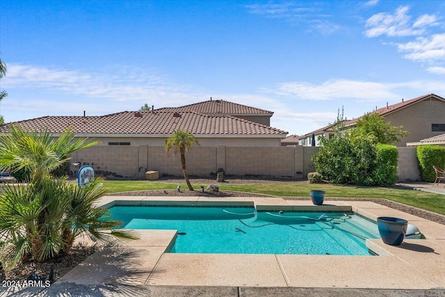 view of pool with a lawn