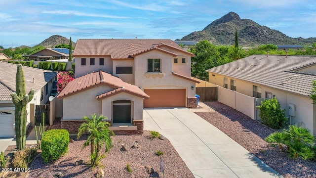 6014 W Oberlin Way, Phoenix, AZ 85083 - mediterranean / spanish home featuring stucco siding, a mountain view, driveway, an attached garage, and a tiled roof