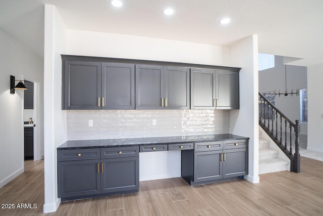 6014 W Oberlin Way, Phoenix, AZ 85083 - kitchen featuring light wood-type flooring, dark stone countertops, decorative backsplash, recessed lighting, and gray cabinets