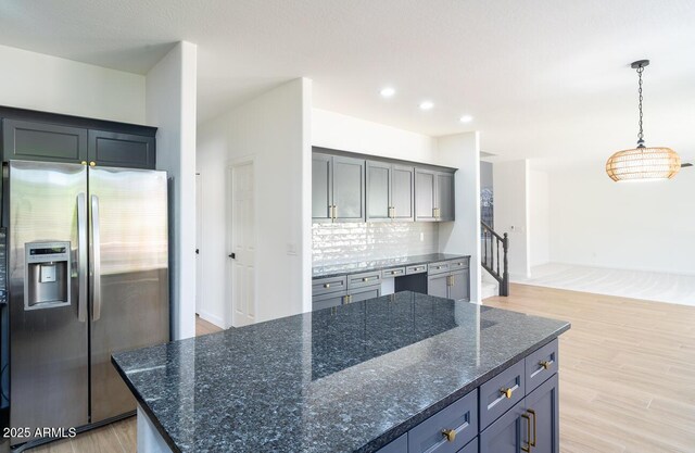 6014 W Oberlin Way, Phoenix, AZ 85083 - kitchen featuring stainless steel fridge with ice dispenser, decorative backsplash, light wood-style floors, recessed lighting, and a center island