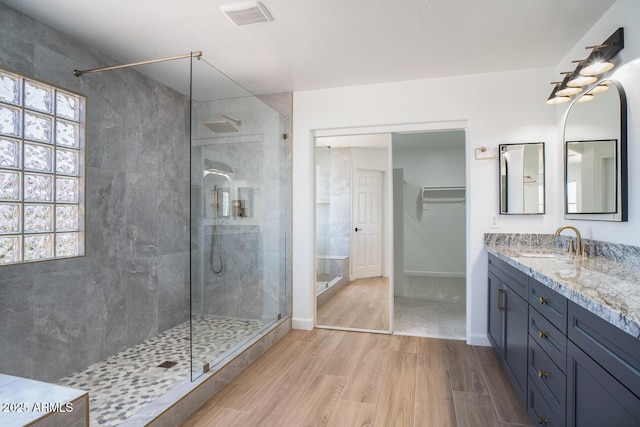 6014 W Oberlin Way, Phoenix, AZ 85083 - bathroom with wood finished floors, a tile shower, and vanity