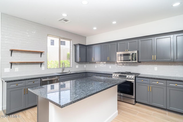 6014 W Oberlin Way, Phoenix, AZ 85083 - kitchen featuring stainless steel appliances, dark stone countertops, light wood-style floors, and recessed lighting