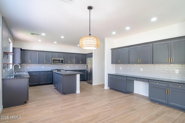 6014 W Oberlin Way, Phoenix, AZ 85083 - kitchen featuring stainless steel appliances, decorative backsplash, a kitchen island, dark stone counters, and recessed lighting