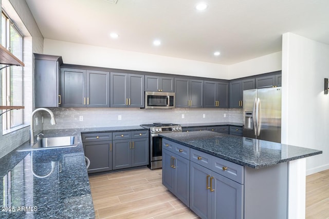 6014 W Oberlin Way, Phoenix, AZ 85083 - kitchen with appliances with stainless steel finishes, dark stone counters, light wood-style flooring, healthy amount of natural light, and recessed lighting