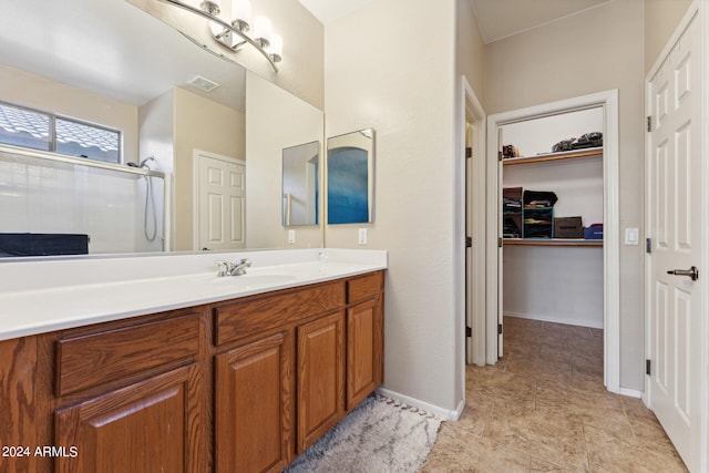 bathroom with a shower with door and vanity