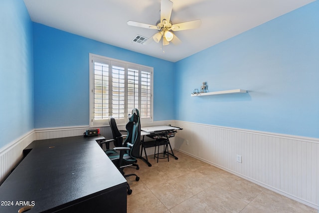 tiled home office featuring ceiling fan