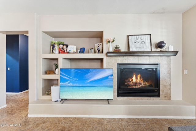 details featuring tile patterned flooring, built in features, and a tile fireplace