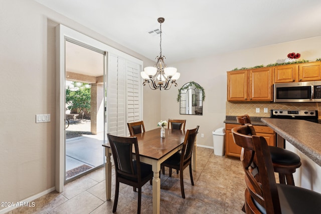 dining space with a chandelier and light tile patterned floors