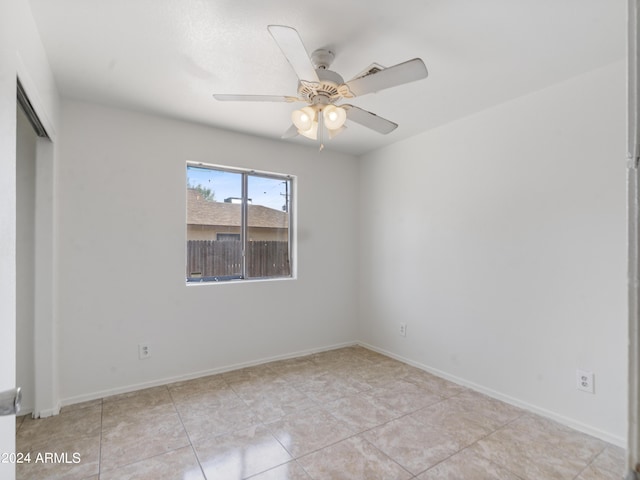 spare room featuring ceiling fan and light tile patterned floors