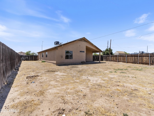 rear view of property featuring central AC