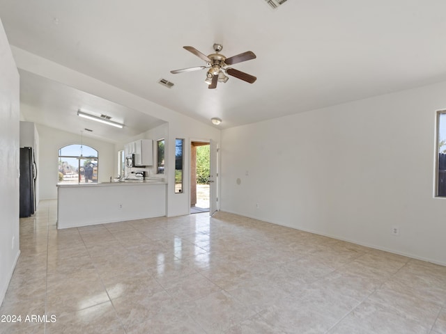 unfurnished living room with lofted ceiling and ceiling fan