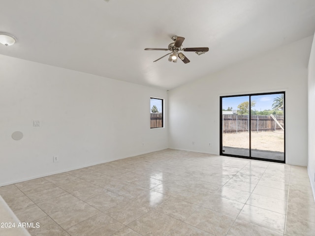 unfurnished room with lofted ceiling, a wealth of natural light, and ceiling fan